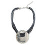 A necklace featuring a cord with multiple strands and a large silver hammered disc pendant.